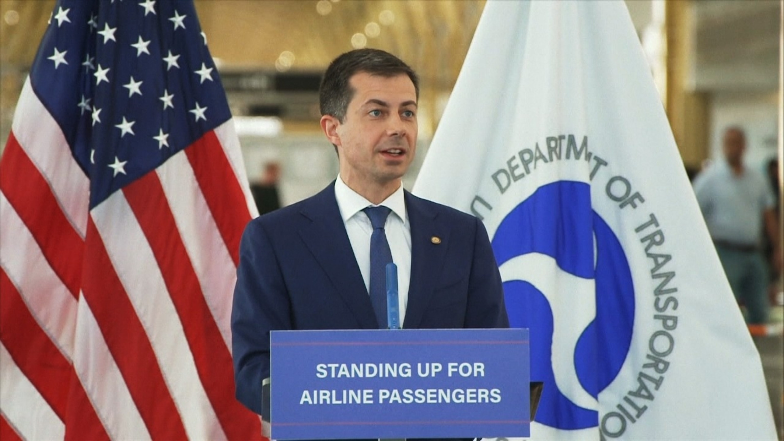 Transportation Secretary Pete Buttigieg announcing new Department of Transportation rules on airline flight delay refunds at a press conference.