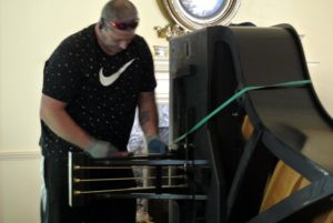 Brian is especially careful when removing the pedals, pushrods and lyre. The pedal box, which may also be called the lyre box, is the wooden housing for the three pedals on the piano. The portion of the pedals that stick out of the pedal box are called the pedal feet.