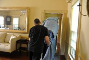 Brian watches that the piano rolls evenly and slowly. He also makes sure none of the walls or the ceiling are touched along the way.