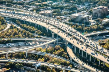 Complex freeway interchange in Houston, Texas, an example of urban areas studied in the Texas A&amp;M Transportation Institute's research on mobility and traffic challenges.