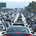 Heavy traffic congestion in Los Angeles, highlighting findings from the Texas A&M Transportation Institute's Urban Mobility Report on the high costs of traffic gridlock.