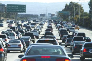 Heavy traffic congestion in Los Angeles, highlighting findings from the Texas A&M Transportation Institute's Urban Mobility Report on the high costs of traffic gridlock.