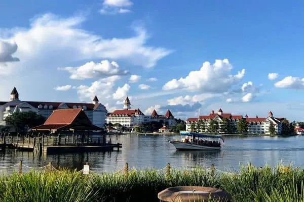 A Disney boat approaching a dock at a resort