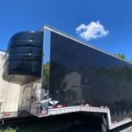 Side view of the 2019 Kentucky 7-Car Enclosed Lift-Gate Trailer showcasing its lift-gate and robust construction, ideal for enclosed auto transport trailers for sale.