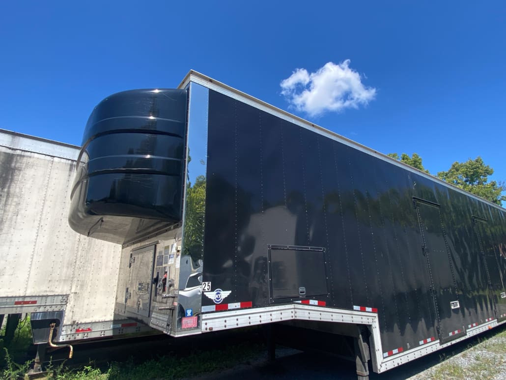 Side view of the 2019 Kentucky 7-Car Enclosed Lift-Gate Trailer showcasing its lift-gate and robust construction, ideal for enclosed auto transport trailers for sale.