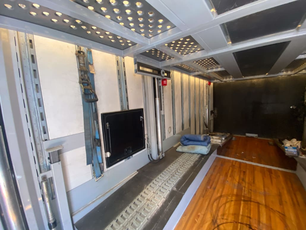 Rear view of the 7-car enclosed trailer, showing the tandem axles and overall structure of enclosed auto transport trailers for sale.