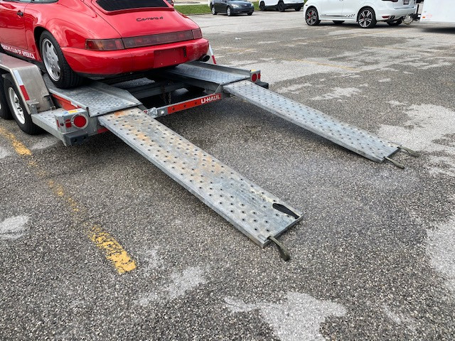 Loading a Porsche 911 onto a U-Haul transport trailer