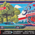 Mural at Pontiac Transportation Museum showcasing hours and automotive theme