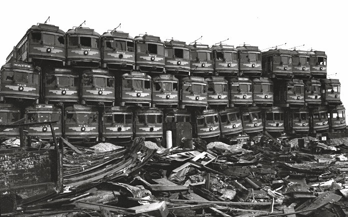 Decommissioned streetcars awaiting destruction in Los Angeles in 1956, symbolizing the decline of streetcar systems.