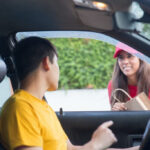 Driver and delivery person handing transportation of goods when starting a transportation business