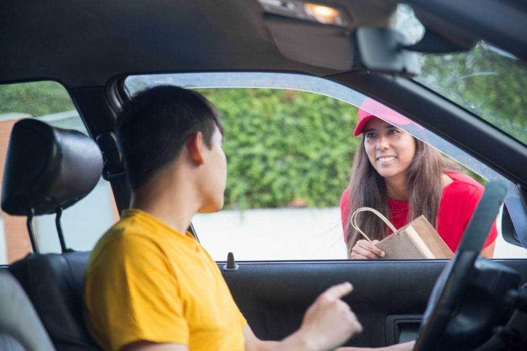 Driver and delivery person handing transportation of goods when starting a transportation business