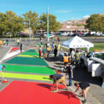 Community members collaborate on a street mural in Salt Lake City's Rose Park neighborhood, part of the Westside Transportation Equity Study to improve equity transportation.