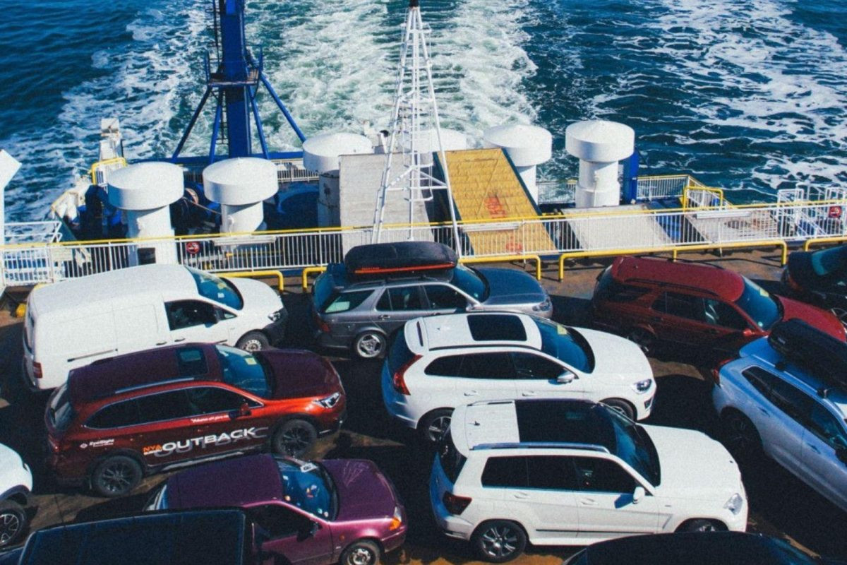 RVs parked at a campground by a lake, illustrating the destination for RV transport and the lifestyle associated with RVs.
