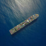 Container ship transporting cars overseas using containerization techniques
