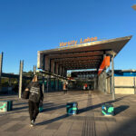 A person swipes their Go Card at a train station in Brisbane, indicating access to public transport.
